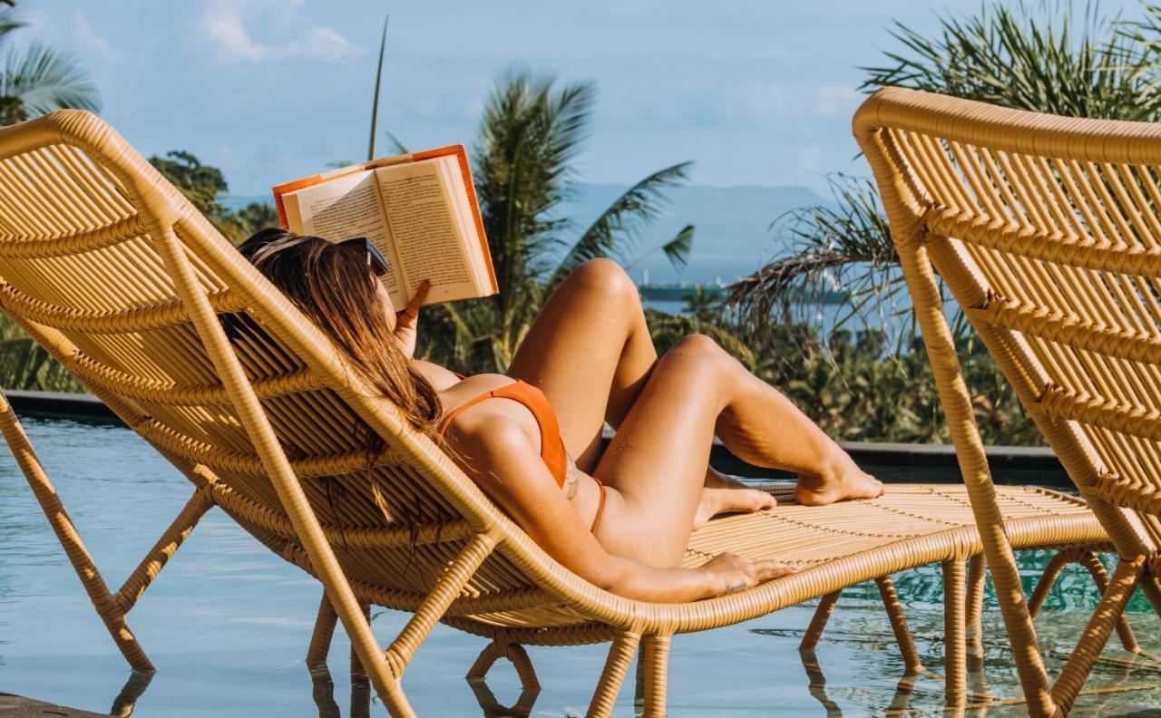 Hotel Neano Escape Manggis Exterior foto A woman reading a book on a beach